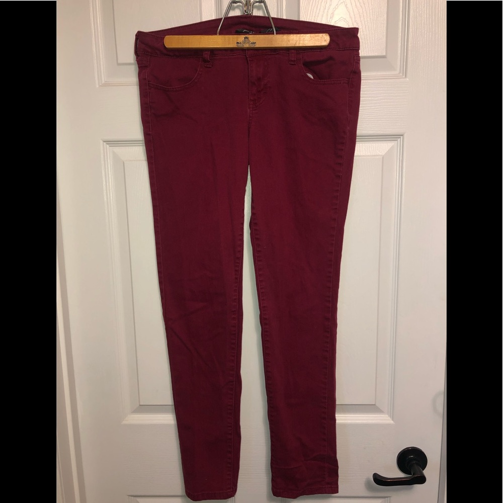 Maroon jeans.